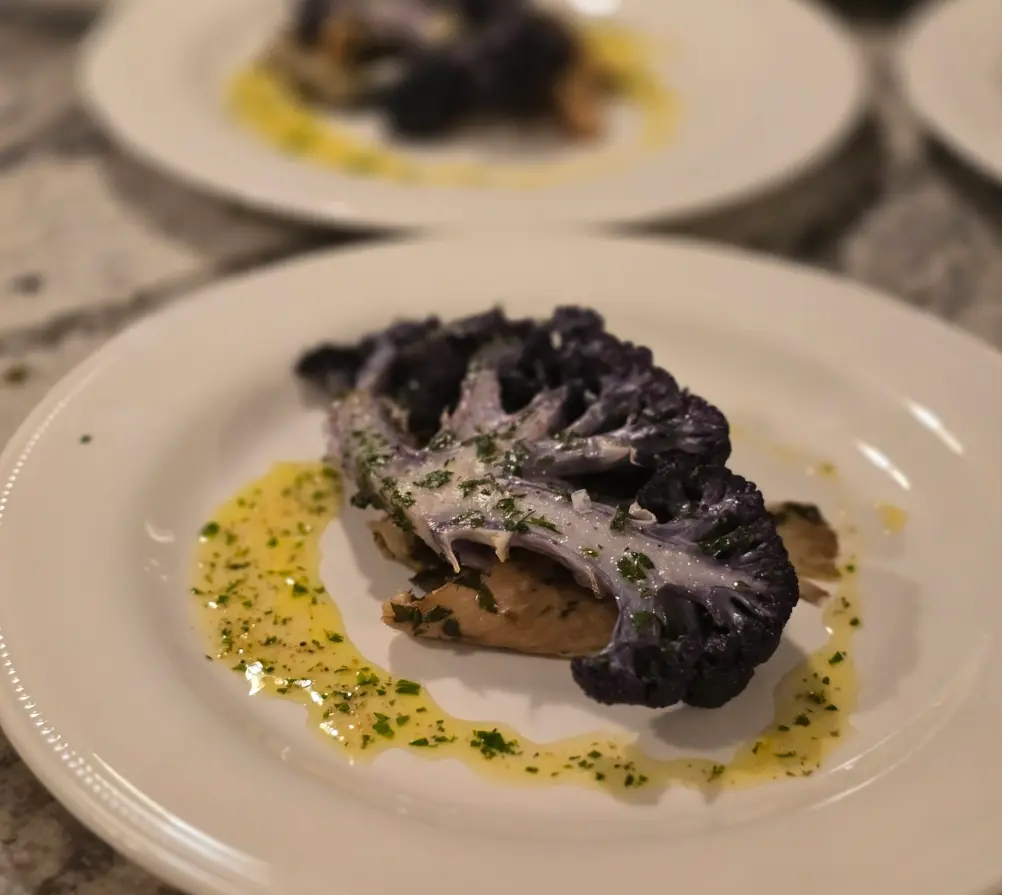 A roasted purple cauliflower steak served with parsley butter.