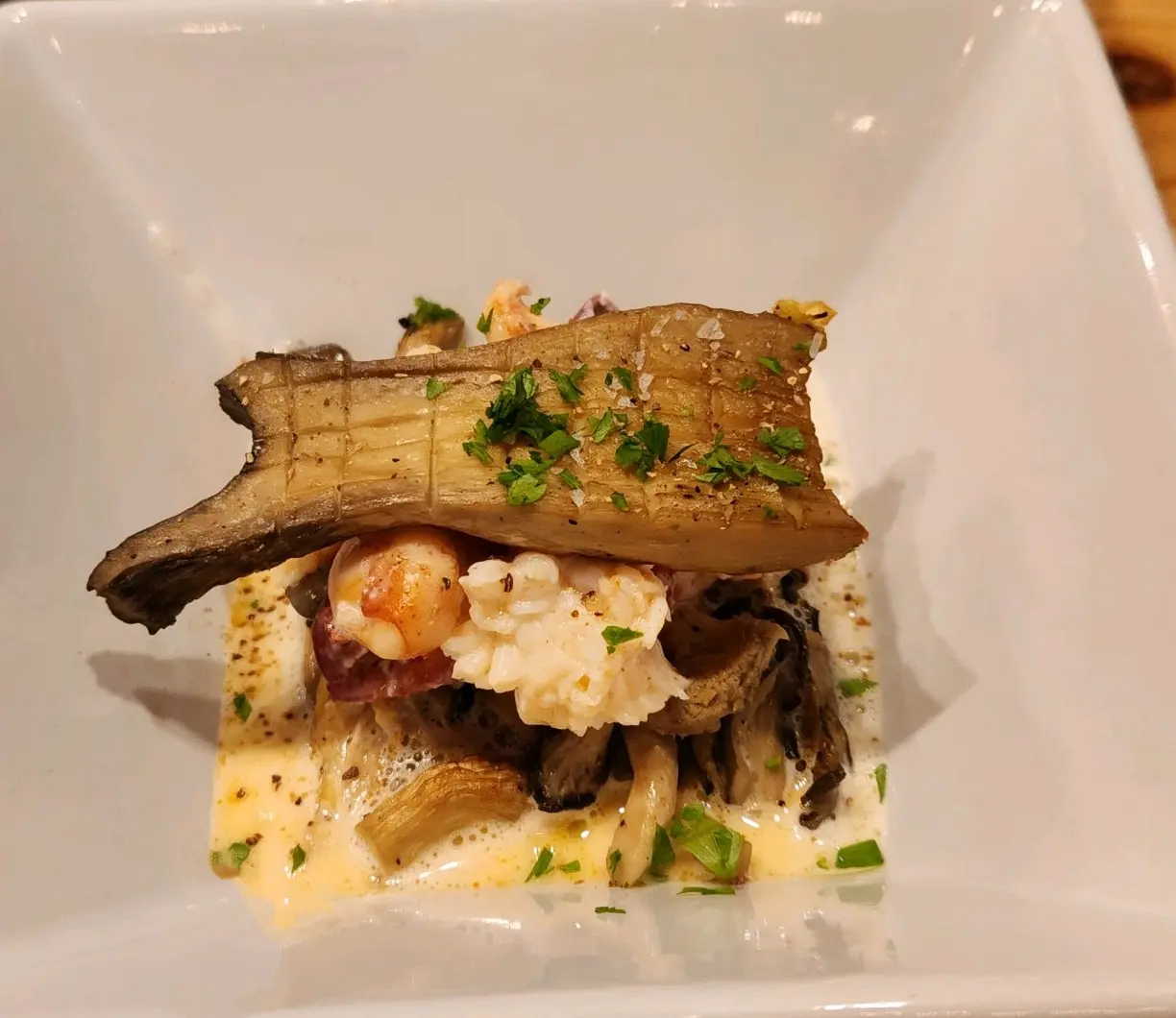 Maine lobster and local mushrooms beneath a long roasted mushroom slice.